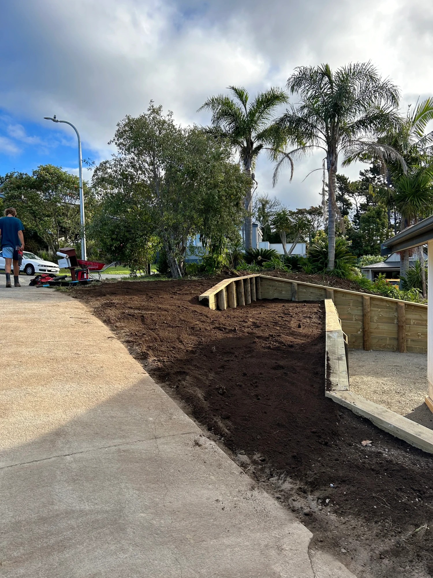 Curved timber retaining wall and landscaping